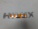 Эмблема для Toyota Hilux 2005-2015, OEM 754270K010 - вид 1 (фото)